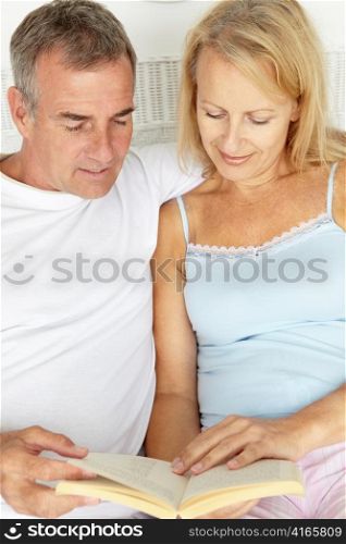 Mid age couple reading together