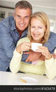 Mid age couple with coffee at home