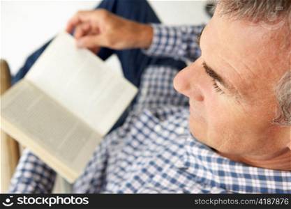 Mid age man reading a book