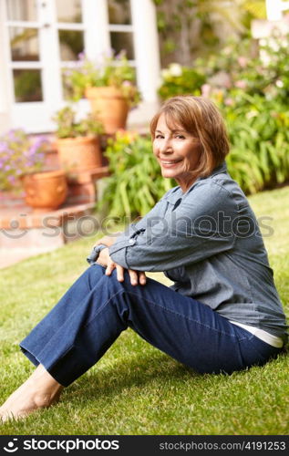 Mid age woman relaxing in garden