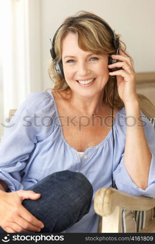 Mid age woman wearing headphones