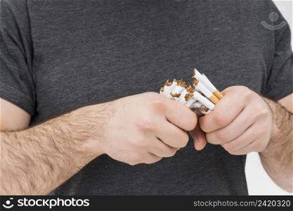 mid section man breaking cigarettes with hands
