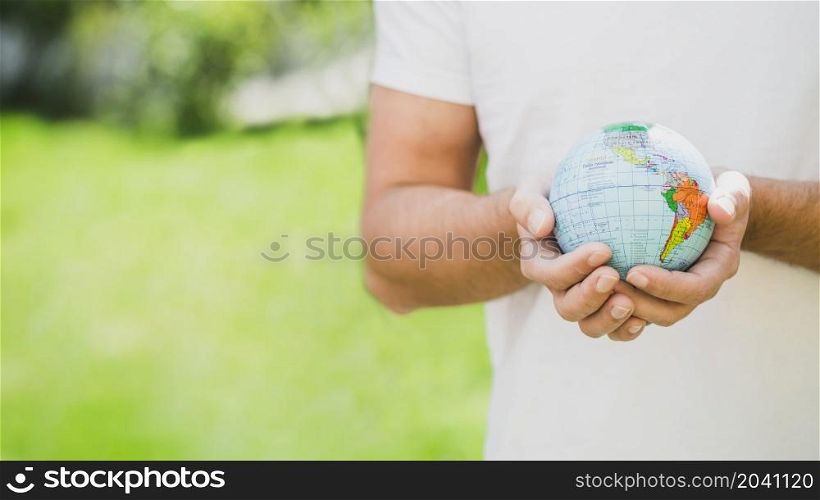 mid section man holding globe hand