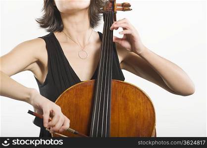 Mid section of female cellist