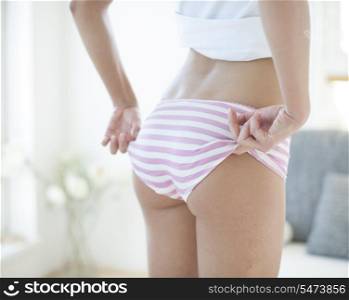 Mid section of woman wearing oversized panty
