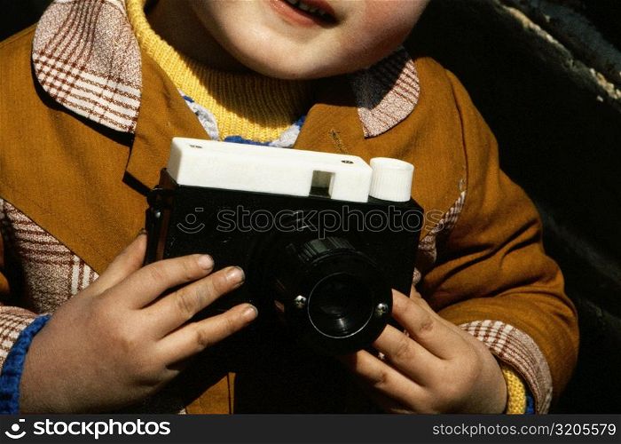 Mid section view of a boy holding a camera, Great Wall Of China, Beijing, China