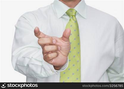 Mid section view of a businessman gesturing with his hand