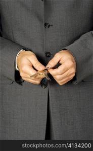 Mid section view of a businessman holding keys
