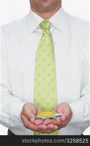 Mid section view of a businessman holding various types of credit cards