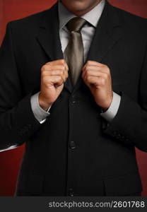 Mid section view of a businessman making a fist