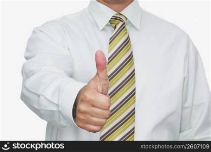 Mid section view of a businessman making a thumbs up sign