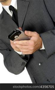 Mid section view of a businessman using a personal data assistant