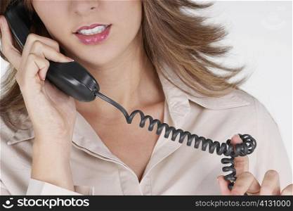 Mid section view of a businesswoman talking on the telephone