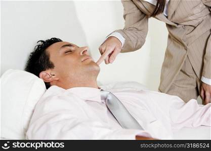 Mid section view of a businesswoman touching a businessman&acute;s chin