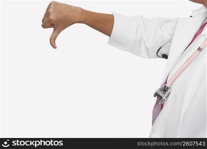 Mid section view of a female doctor showing a thumbs down sign