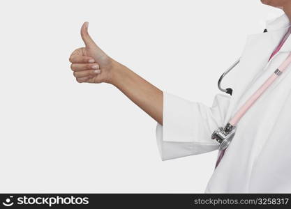 Mid section view of a female doctor showing a thumbs up sign