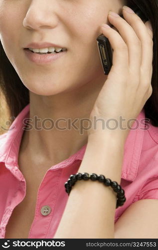 Mid section view of a female office worker talking on a mobile phone