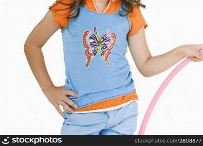 Mid section view of a girl holding a hula hoop