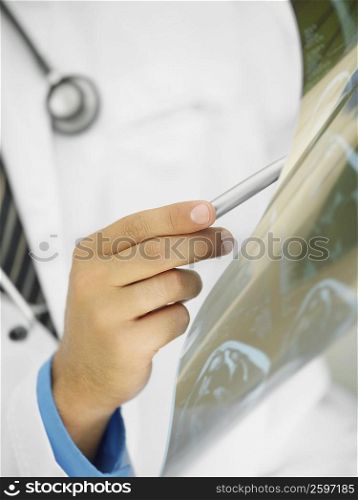Mid section view of a male doctor examining an X-Ray