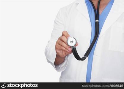 Mid section view of a male doctor holding a stethoscope