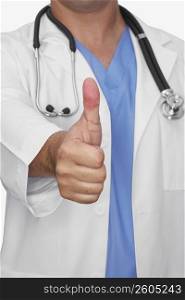 Mid section view of a male doctor showing a thumbs up sign
