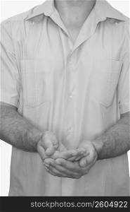 Mid section view of a male nurse cupping his hands