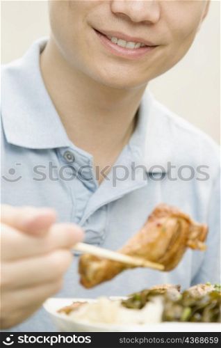 Mid section view of a male office worker having lunch