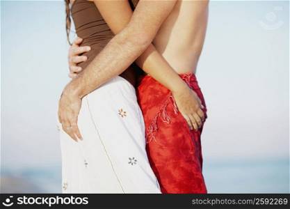 Mid section view of a man and a woman embracing each other