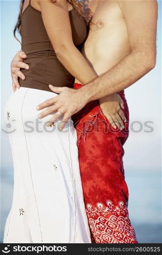 Mid section view of a man and a woman embracing each other