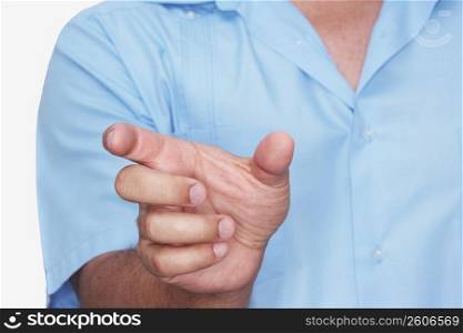 Mid section view of a man gesturing with his hand