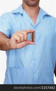 Mid section view of a man holding a domino