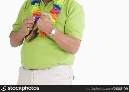 Mid section view of a man playing ukulele