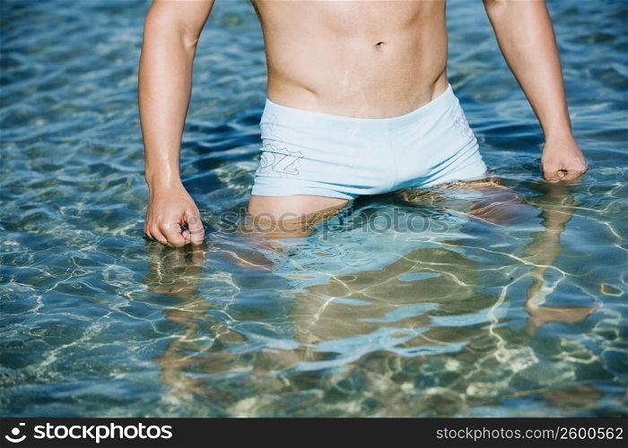 Mid section view of a man standing in water