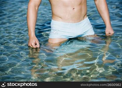 Mid section view of a man standing in water