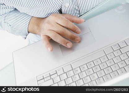 Mid section view of a man working on a laptop