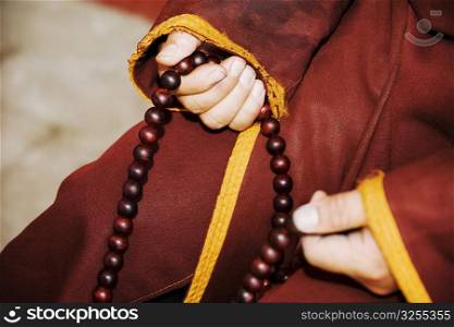 Mid section view of a person&acute;s hand holding a prayer beads, Da Zhao Temple, Hohhot, Inner Mongolia, China