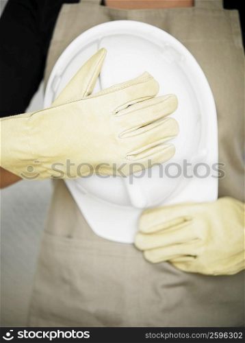 Mid section view of a person holding a hardhat