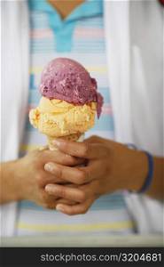 Mid section view of a person holding an ice-cream