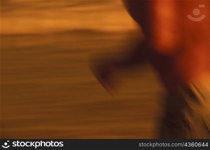 Mid section view of a person jogging on the beach, Caribbean