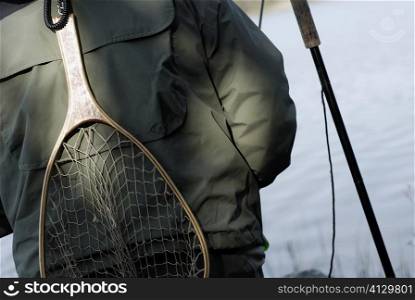 Mid section view of a person with a fishing net on his back