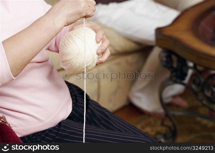 Mid section view of a senior woman holding a ball of wool
