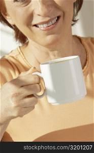 Mid section view of a senior woman holding a cup of coffee