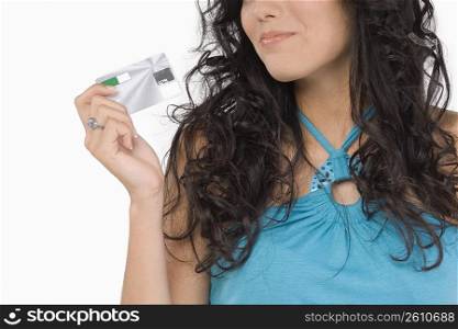 Mid section view of a teenage girl holding a credit card