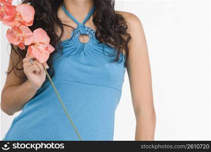 Mid section view of a teenage girl holding flowers