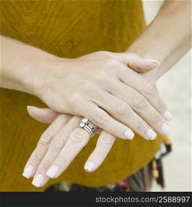 Mid section view of a woman&acute;s hands