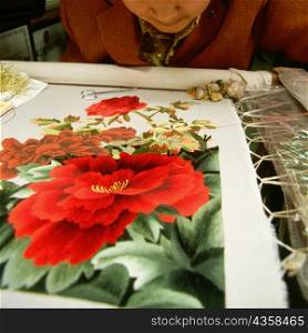 Mid section view of a woman embroidering a sheet, Zhouzhuang, Kunshan City, Jiangsu Province, China