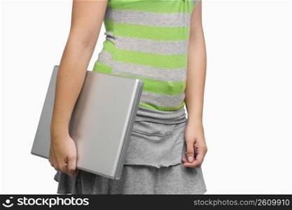 Mid section view of a woman holding a laptop