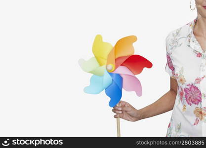 Mid section view of a woman holding a pinwheel