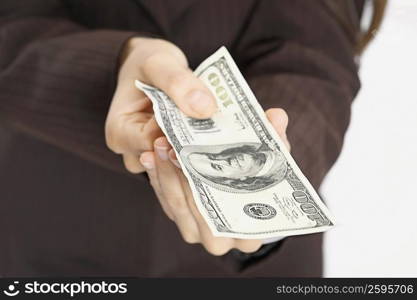 Mid section view of a woman holding American paper currency