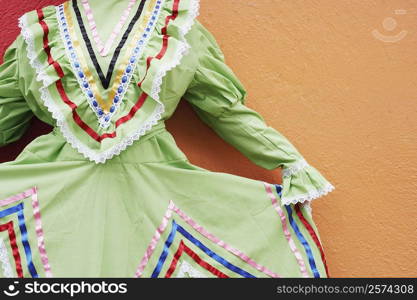 Mid section view of a woman holding her dress